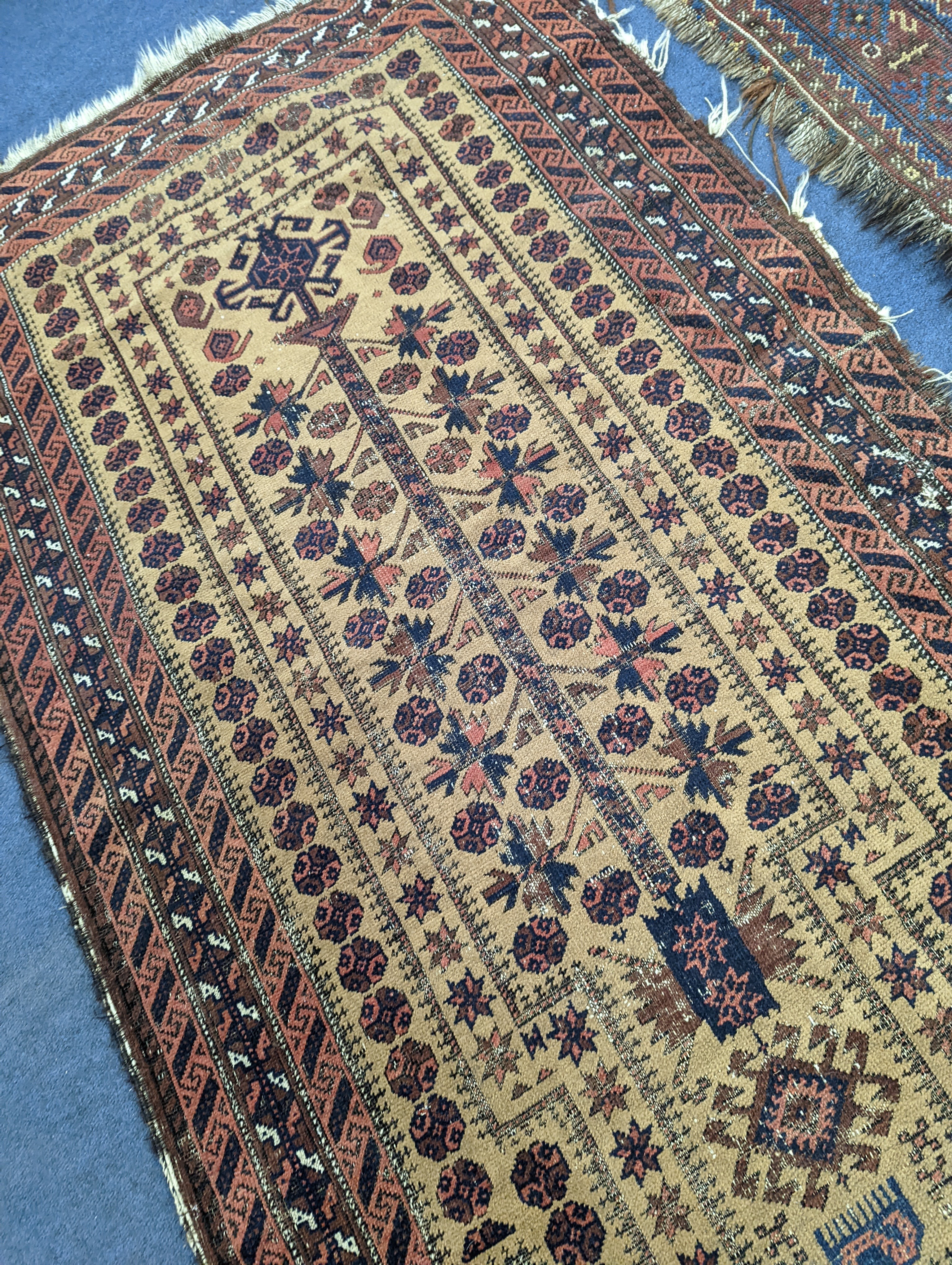 A Caucasian red ground rug and a Belouch rug, larger 200 x 165cm